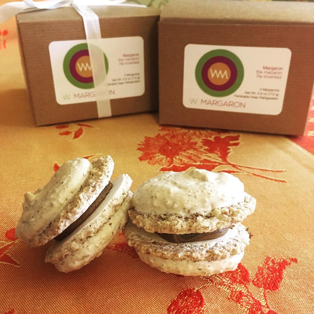 Caption: Showcasing a margaron (highly textured macaron) and a gift box containing the old logo.